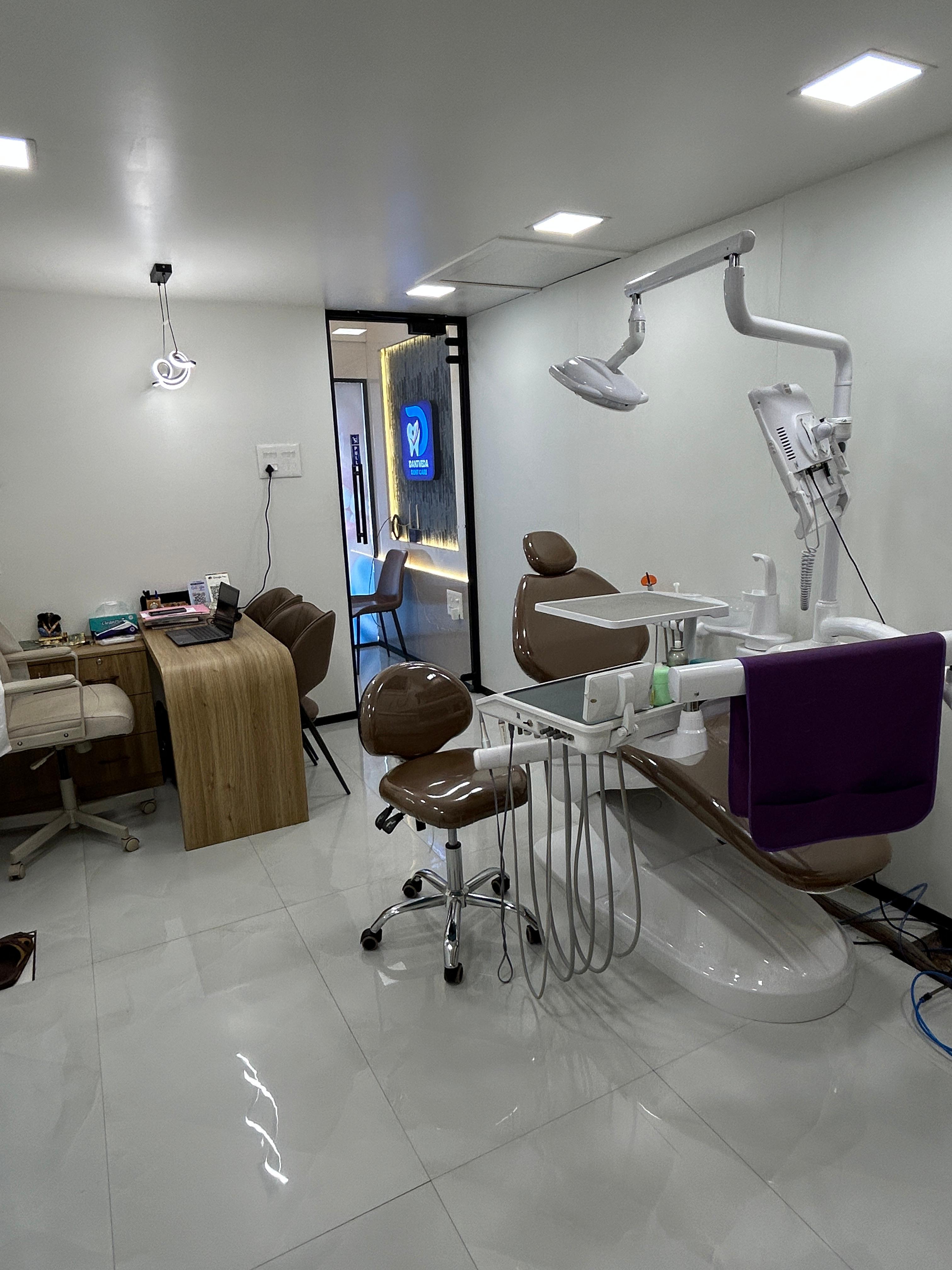 Dantveda Dent Care treatment room with dental chair and branded signage